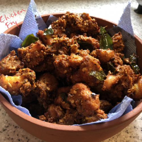 Bowl of chicken fry with a label on a countertop