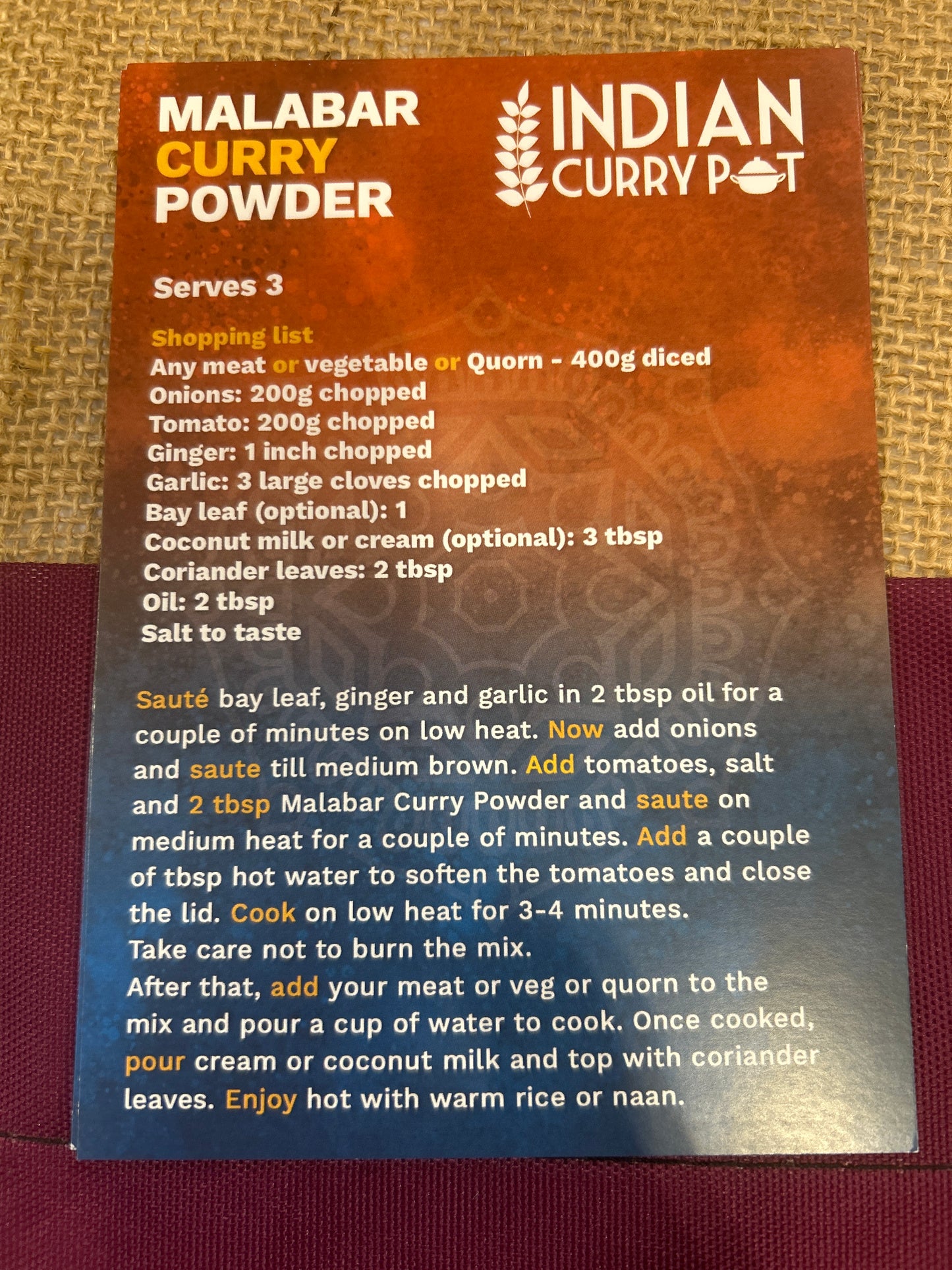 Indian Curry Pot Malabar Curry Powder packaging with text on a textured surface