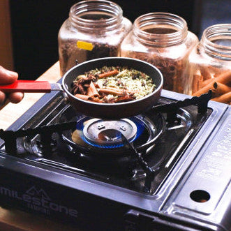 Small pan ovef gas hob roasting spices