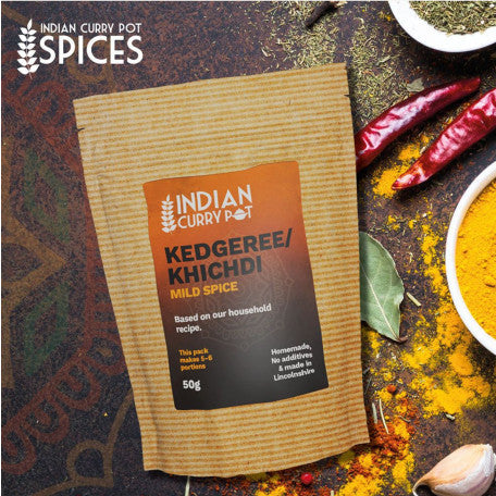 Kedgeree/Khichdi spice package with spices and ingredients on a rustic background