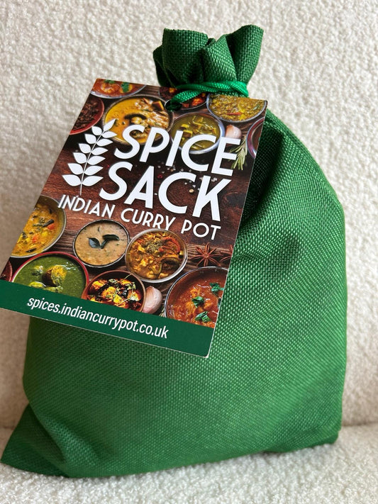 Green spice sack with 'Spice Sack Indian Curry Pot' label on a textured white background
