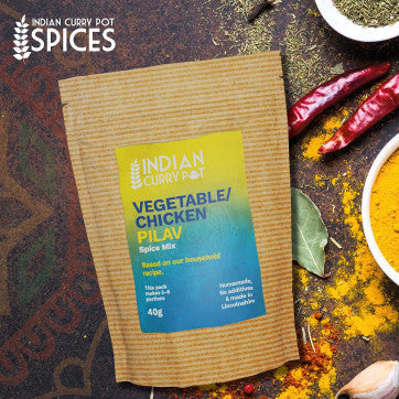 Spice mix package with ingredients on a rustic background, featuring 'Indian Curry Pot' branding.